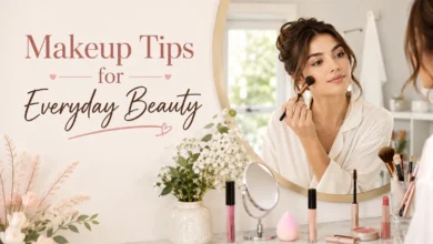 Young woman applying natural everyday makeup at a vanity with concealer, mascara, blush, and beauty essentials in a bright, elegant setting.