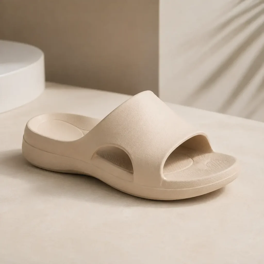 Beige women's Archies arch support slide sandal with a cushioned contoured footbed and wide slip-on strap on a neutral studio background.