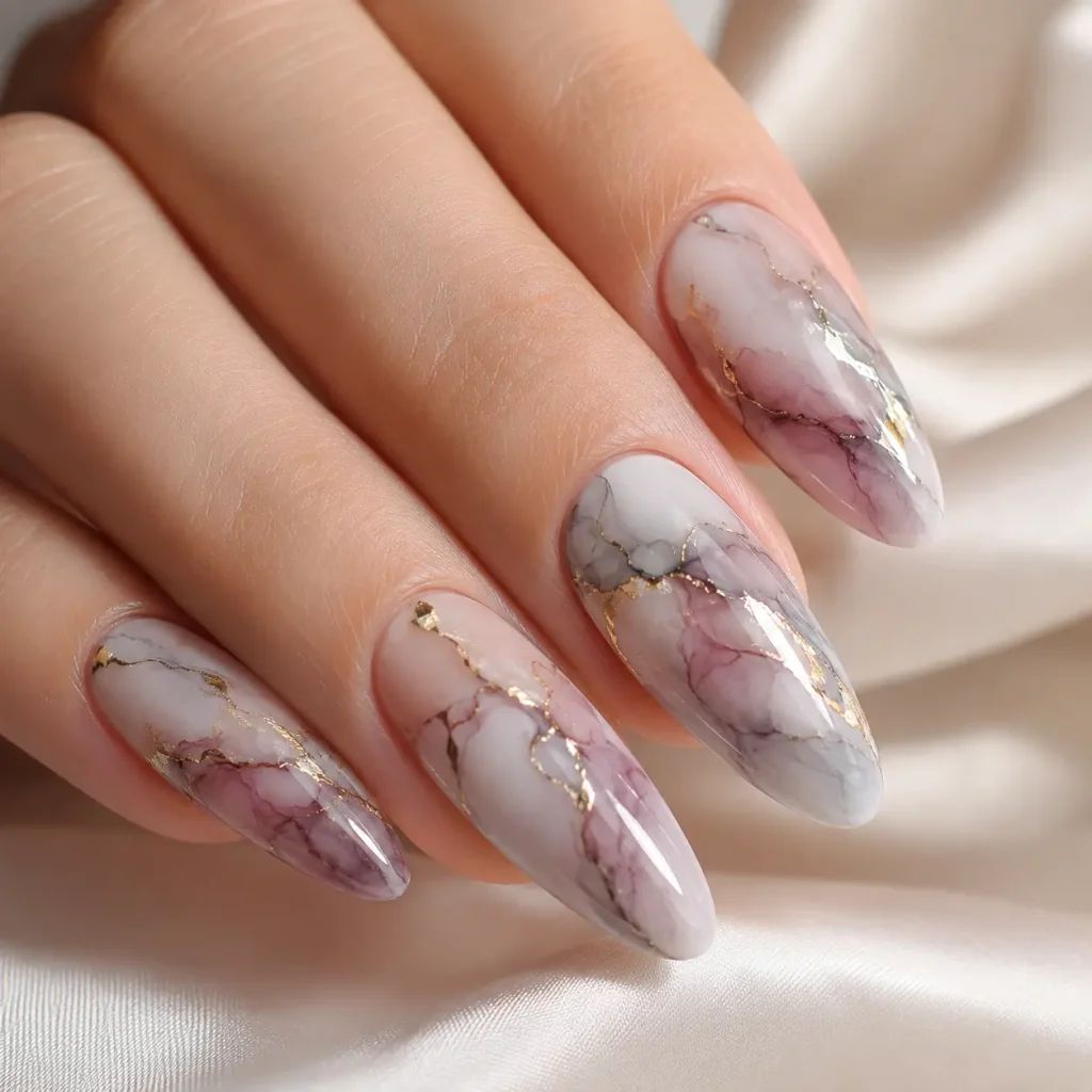 Marble blooming nails with soft pink, gray, and mauve swirls accented by delicate gold veins