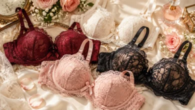 Elegant lacy bras collection featuring romantic floral lace designs arranged on luxurious satin fabric with soft rose accents.