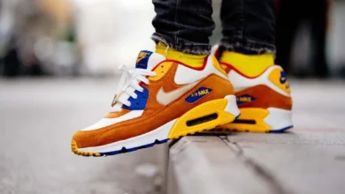 Orange, yellow, and white athletic sneakers styled with black jeans for a modern streetwear look, showing how to wear sneakers from gym wear to everyday casual outfits.