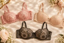 Old Navy women's lace balconette bra styles in pink floral lace, beige mesh-dot, and dark sunflower lace displayed on soft cream fabric with flowers.
