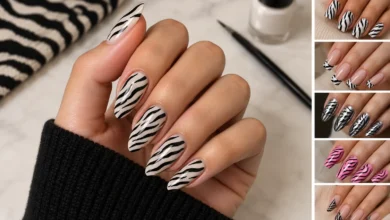 Zebra print nails featuring glossy black stripes on a nude base with stylish manicure designs and a modern beauty aesthetic.